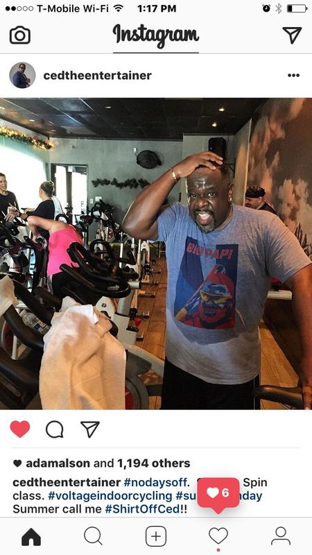 Cedric the Entertainer at a spin class wearing a gray 500 Level 'Big Papi' David Ortiz T-shirt in an Instagram post.