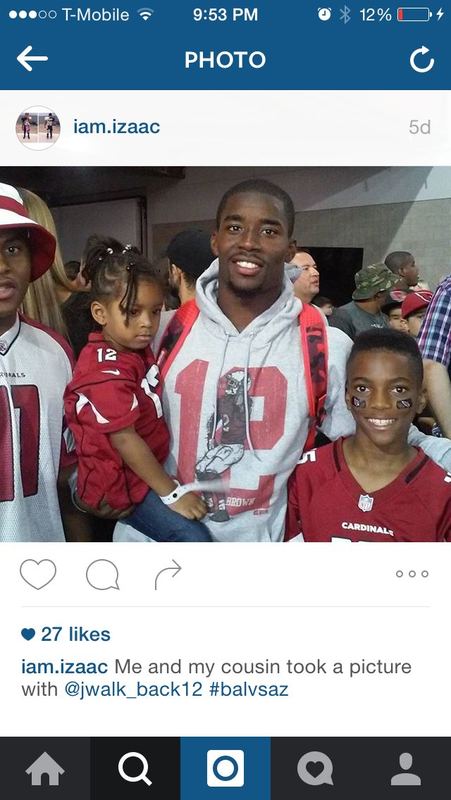 Arizona Cardinals receiver John Brown posing with young fans while wearing his own number 12 'Brown' 500 Level hoodie.