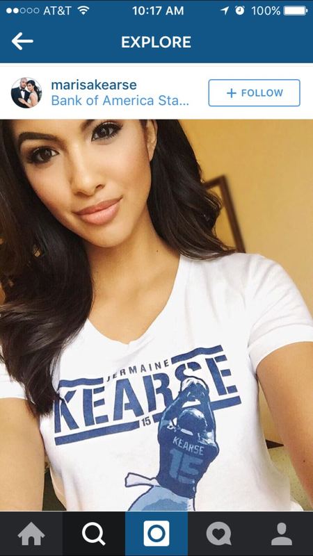 Marisa Kearse taking a selfie in a white 500 Level 'Jermaine Kearse 15' T-shirt.