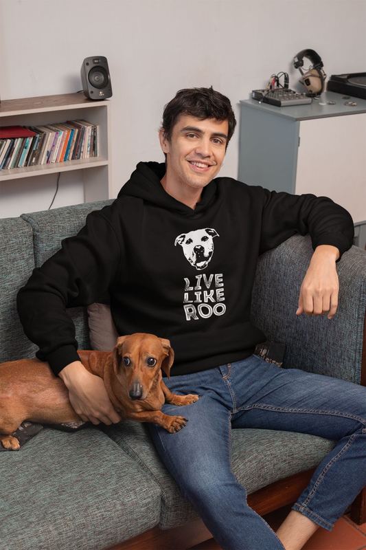 pullover hoodie mockup featuring a young man sitting on a couch with his dog 30681 — ROO SWAG